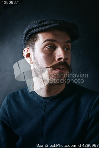 Image of The young man in cap at studio