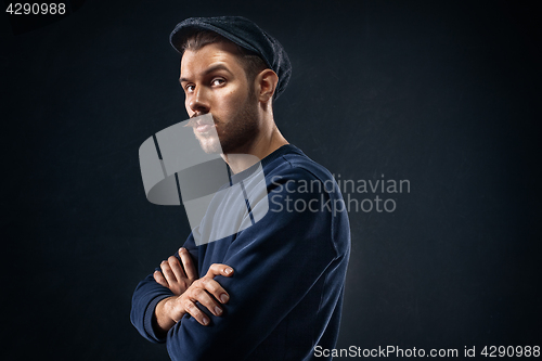 Image of The young man in cap at studio