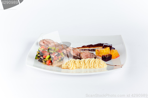 Image of Close Up of Rack of Saucy Barbecue Pork Served on Plate in Restaurant