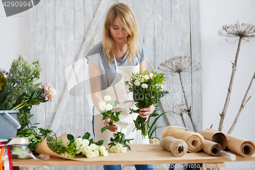 Image of Young woman in flower shop