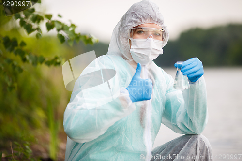 Image of Chemist with bulb , river bank