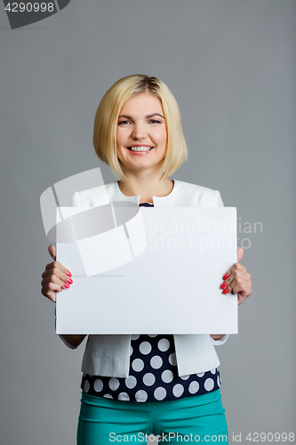 Image of Young blonde with blank sheet