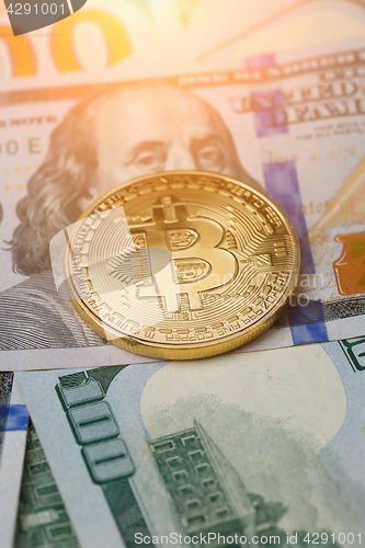 Image of Image of dollars with golden bitcoin,