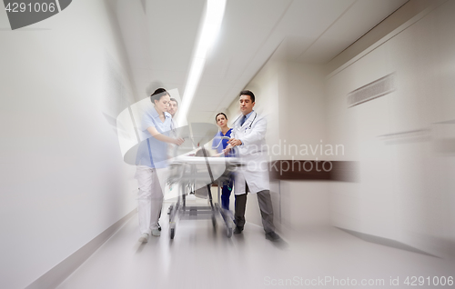 Image of medics and patient on hospital gurney at emergency