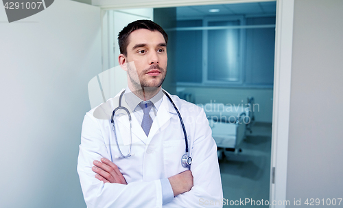 Image of doctor with stethoscope at hospital corridor