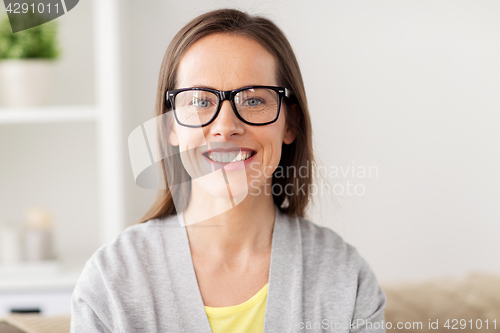 Image of happy smiling middle aged woman in glasses at home