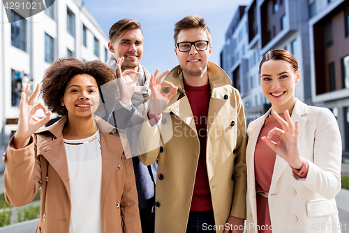 Image of international business team showing ok hand sign