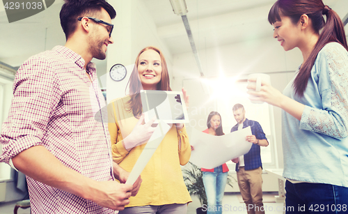 Image of creative team with tablet pc talking at office