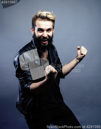 Image of portrait of young bearded hipster guy on gray dark background close up, brutal modern man, lifestyle people concept 