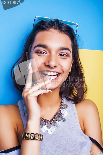 Image of young cheerful indian mixed races girl happy smiling, posing on blue background in summer fashion clothers. lifestyle people concept