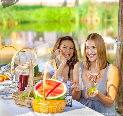 Image of beautiful laughing women at a festive table