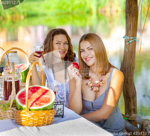 Image of Two beautiful women on a picnic