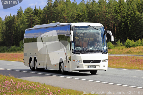Image of White Volvo Bus on Summer Freeway