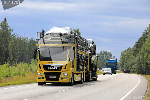 Image of Yellow MAN Car Carrier Hauls New Cars