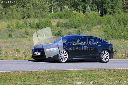 Image of Tesla Model S Electric Car in Green Scenery