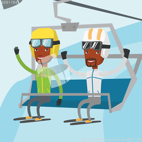 Image of Two happy skiers using cableway at ski resort.