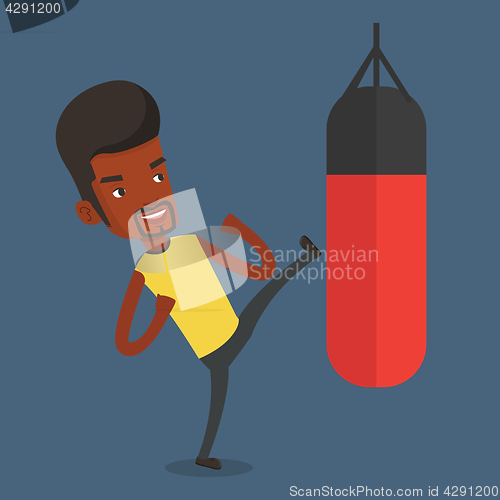 Image of Man exercising with punching bag.