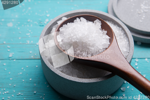 Image of sea salt in stone bowl and wooden spoon