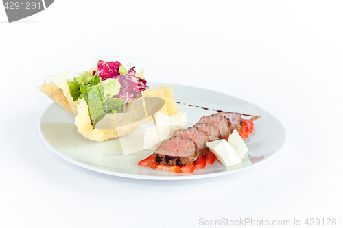 Image of Close Up of Rack of Saucy Barbecue Pork Served on Plate in Restaurant