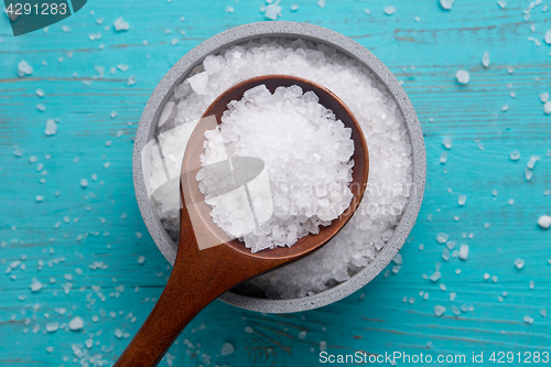 Image of sea salt in stone bowl and wooden spoon