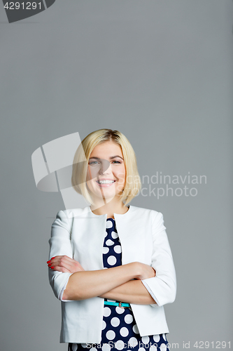 Image of Smiling blonde with arms crossed