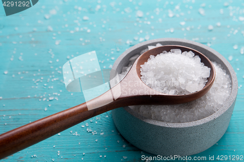 Image of sea salt in stone bowl and wooden spoon