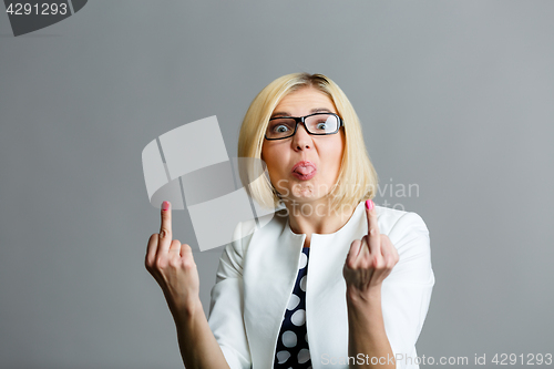 Image of Girl shows tongue and finger