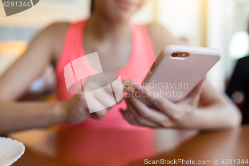 Image of Woman sending sms on mobile phone