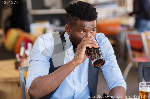 Image of man drinking draught beer at bar or pub