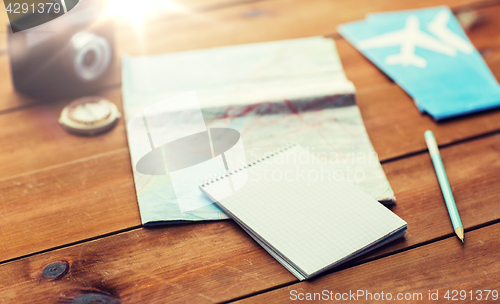 Image of close up of notepad with map and travel tickets