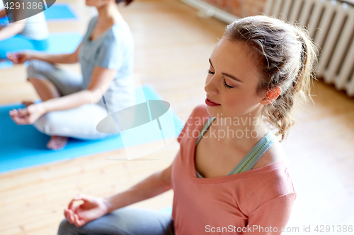 Image of woman meditating at yoga studio