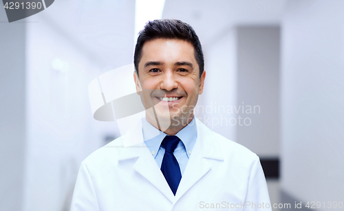 Image of smiling doctor in white coat at hospital