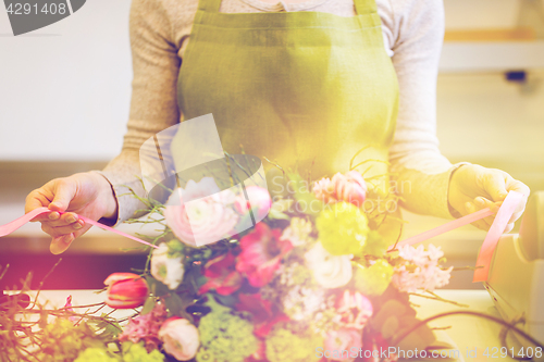 Image of close up of woman making bunch at flower shop