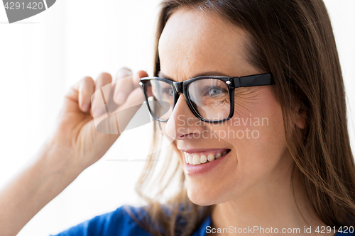 Image of close up of smiling middle aged woman in glasses