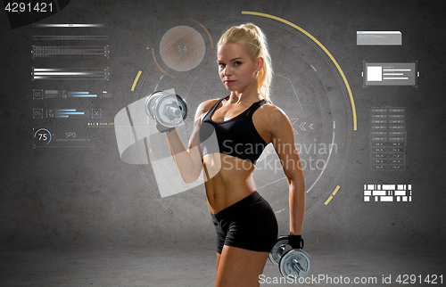 Image of happy young sporty woman exercising with dumbbells