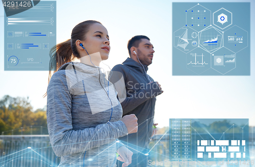 Image of happy couple with earphones running outdoors