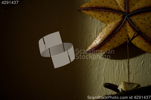 Image of dark wall with wooden starfish