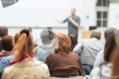 Image of Man giving presentation in lecture hall at university.