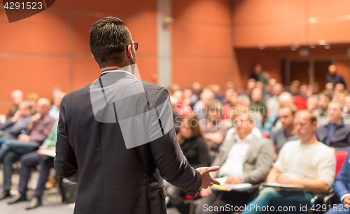 Image of Public speaker giving talk at Business Event.