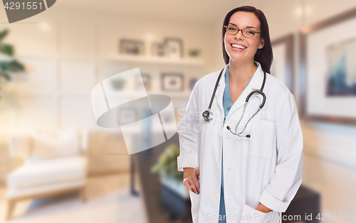 Image of Young Female Doctor or Nurse Standing in Her Office