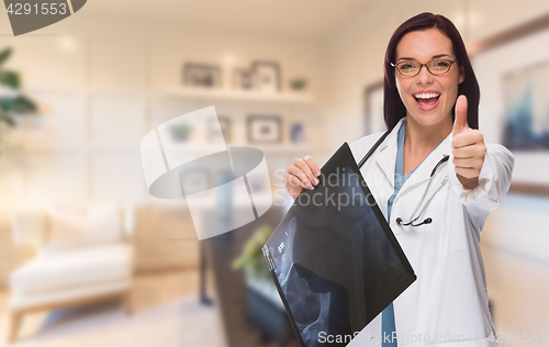 Image of Young Female Doctor or Nurse with Thumbs Up Standing in Office H