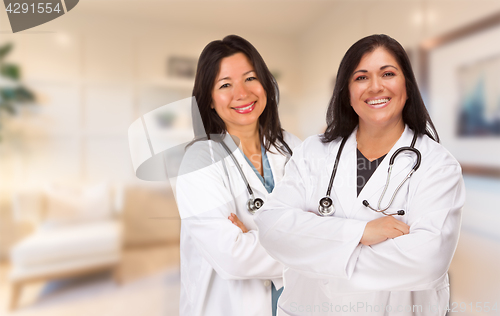 Image of Female Hispanic Doctors or Nurses Standing in an Office