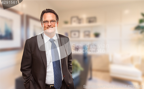 Image of Handsome Businessman In Suit and Tie Standing in His Office