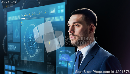 Image of businessman with virtual screen over black