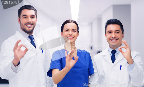 Image of group of medics at hospital showing ok hand sign