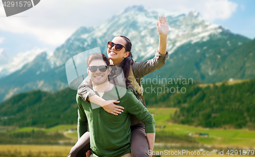 Image of happy couple with backpacks having fun outdoors