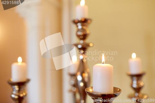 Image of candles burning in church