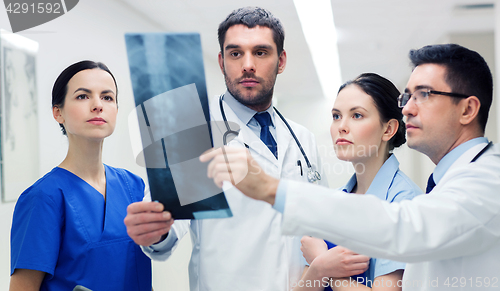 Image of group of medics with spine x-ray scan at hospital