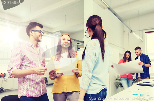 Image of creative team on coffee break talking at office