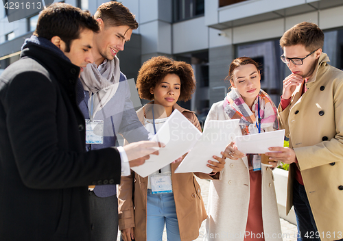 Image of international business team with papers in city